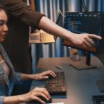 Twórcy IT dyskutują o inteligentnej stronie internetowej z laptopem pokazującym dane Infobahn