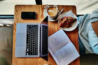 a laptop computer sitting on top of a wooden desk